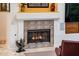 Close-up view of the fireplace with decorative tile surround and mantel, a warm and inviting focal point at 19644 N Majestic Vista Ct, Surprise, AZ 85387