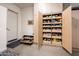 Organized garage with cabinets, shoe rack, and plenty of storage space for an efficient living space at 19644 N Majestic Vista Ct, Surprise, AZ 85387