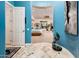 Hallway with blue walls leading to a bedroom, showcasing unique decor and elegant flooring at 19644 N Majestic Vista Ct, Surprise, AZ 85387