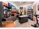 Spacious home office with built-in cabinets, bookshelves, a large desk, and bright natural light at 19644 N Majestic Vista Ct, Surprise, AZ 85387