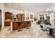 Open kitchen with an island, wood cabinetry, stone countertops, and stainless steel appliances at 19644 N Majestic Vista Ct, Surprise, AZ 85387