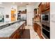 Kitchen featuring granite countertops, stainless steel appliances, and wood cabinets at 19644 N Majestic Vista Ct, Surprise, AZ 85387
