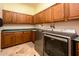 Well-organized laundry room with wood cabinets, ample counter space, and modern washer and dryer at 19644 N Majestic Vista Ct, Surprise, AZ 85387