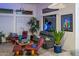 Cozy living room with plants, leather seating, and window views at 19644 N Majestic Vista Ct, Surprise, AZ 85387