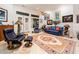 Inviting living room featuring bright natural light, plush blue seating, and stylish decor at 19644 N Majestic Vista Ct, Surprise, AZ 85387