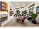 Inviting living room with large windows, a fireplace, and comfortable leather seating at 19644 N Majestic Vista Ct, Surprise, AZ 85387