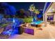 Backyard with outdoor kitchen, barbecue, seating, lush landscape, and sparkling pool at 19644 N Majestic Vista Ct, Surprise, AZ 85387