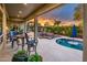 Outdoor entertaining space with a kitchen, bar and seating, all with sunset views from the covered patio at 19644 N Majestic Vista Ct, Surprise, AZ 85387