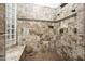 Large walk-in shower features tiled walls, dual shower heads, a bench, and a grab bar for safety at 19644 N Majestic Vista Ct, Surprise, AZ 85387
