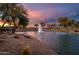 Picturesque water view showcasing a fountain, desert landscaping, and golf course at sunset at 19644 N Majestic Vista Ct, Surprise, AZ 85387