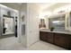 Bathroom featuring a double sink vanity, and access to the bedroom and walk-in closet at 20721 W Fern Dr, Buckeye, AZ 85396