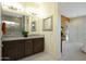 Bathroom featuring a double sink vanity, white cabinets and light fixtures at 20721 W Fern Dr, Buckeye, AZ 85396