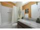 Bathroom featuring a granite countertop vanity, decorative mirror, and a bathtub with a white shower curtain at 20721 W Fern Dr, Buckeye, AZ 85396