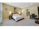 Bedroom featuring neutral paint, modern lighting, and access to an en-suite bath at 20721 W Fern Dr, Buckeye, AZ 85396