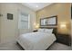 Cozy bedroom with a comfortable bed, natural lighting, and side tables with decorative lamps at 20721 W Fern Dr, Buckeye, AZ 85396
