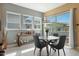 Bright dining area with large windows, stylish lighting, and a sliding door to the outdoors at 20721 W Fern Dr, Buckeye, AZ 85396