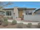 Inviting home with a yellow front door, well-manicured landscaping, and modern architectural accents at 20721 W Fern Dr, Buckeye, AZ 85396