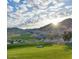 Scenic golf course view with desert landscape and mountains, ideal for golf enthusiasts at 20721 W Fern Dr, Buckeye, AZ 85396