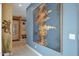 Hallway with tile flooring, large contemporary artwork and decor at 20721 W Fern Dr, Buckeye, AZ 85396