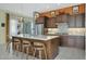 Modern kitchen featuring a large island with bar seating, stainless steel appliances, and stylish lighting at 20721 W Fern Dr, Buckeye, AZ 85396