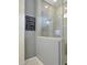 Modern bathroom shower with glass enclosure and grey tiled walls, next to a motivational art piece at 20721 W Fern Dr, Buckeye, AZ 85396