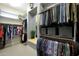 Spacious walk-in closet with multiple rods for hanging clothes, shelving, and ample storage containers at 20721 W Fern Dr, Buckeye, AZ 85396