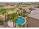An aerial view features an in-ground pool and manicured backyard adjacent to a golf course at 22139 N O Sullivan Dr, Maricopa, AZ 85138