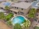 An aerial view reveals a backyard with a pool, hot tub, putting green, and covered patio at 22139 N O Sullivan Dr, Maricopa, AZ 85138