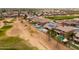 An aerial view shows a home with pool by green golf course at 22139 N O Sullivan Dr, Maricopa, AZ 85138