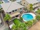 A backyard features a pool, putting green, covered patio, and mature palm trees at 22139 N O Sullivan Dr, Maricopa, AZ 85138