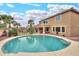 A large in-ground pool is surrounded by palm trees, with a putting green, and a hot tub at 22139 N O Sullivan Dr, Maricopa, AZ 85138