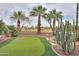 Picturesque backyard with a putting green, desert landscaping, and a view of the surrounding area at 22139 N O Sullivan Dr, Maricopa, AZ 85138