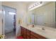 Well-lit bathroom with double sinks and a shower/tub combo at 22139 N O Sullivan Dr, Maricopa, AZ 85138