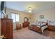 Traditional bedroom with a ceiling fan, window, and wood furniture at 22139 N O Sullivan Dr, Maricopa, AZ 85138