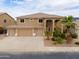 Two-story home featuring a three-car garage, desert landscaping, and well-maintained lawn at 22139 N O Sullivan Dr, Maricopa, AZ 85138