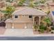 Inviting two-story home with a three-car garage, desert landscaping, and a tile roof at 22139 N O Sullivan Dr, Maricopa, AZ 85138