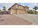 A two-story home featuring a three-car garage, desert landscaping, and a tile roof at 22139 N O Sullivan Dr, Maricopa, AZ 85138
