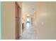 Neutral-toned hallway with tile flooring and a view into a bathroom with ample storage at 22139 N O Sullivan Dr, Maricopa, AZ 85138