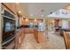 Spacious kitchen with stainless steel oven and microwave, granite countertops, and tile flooring at 22139 N O Sullivan Dr, Maricopa, AZ 85138