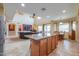 Open-concept kitchen with granite island, tile flooring, and stainless steel appliances at 22139 N O Sullivan Dr, Maricopa, AZ 85138