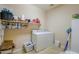 Practical laundry room with shelving, washer, dryer, and tiled floor for easy maintenance at 22139 N O Sullivan Dr, Maricopa, AZ 85138
