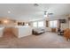 Spacious living room features large windows, carpeted floors, and neutral paint throughout at 22139 N O Sullivan Dr, Maricopa, AZ 85138