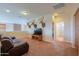 Second living room features recessed lights, comfortable seating, and TV with storage at 22139 N O Sullivan Dr, Maricopa, AZ 85138