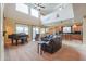 Bright living room with piano, leather furniture, high ceilings, and a view into the kitchen at 22139 N O Sullivan Dr, Maricopa, AZ 85138