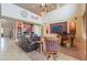 Cozy living room with a comfortable leather sofa, piano, and high ceilings at 22139 N O Sullivan Dr, Maricopa, AZ 85138