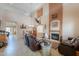 Open-concept living room and dining area with high ceilings, tile floors, and a fireplace at 22139 N O Sullivan Dr, Maricopa, AZ 85138