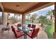 Covered patio with dining set overlooking pool and lush landscaping creates an outdoor oasis at 22139 N O Sullivan Dr, Maricopa, AZ 85138