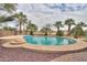 The in-ground pool has coping, steps, and a metal handrail for easy access at 22139 N O Sullivan Dr, Maricopa, AZ 85138