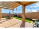 Entertaining backyard featuring patio area with pergola, pool, and artificial grass at 23791 W Magnolia Dr, Buckeye, AZ 85326