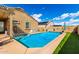 Backyard featuring a private pool with artificial turf, perfect for relaxing and entertaining at 23791 W Magnolia Dr, Buckeye, AZ 85326